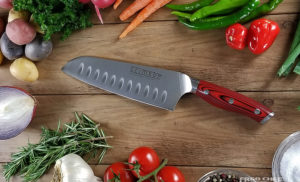 Crimson G10 7 inch Santoku Knife on cutting board with vegetables