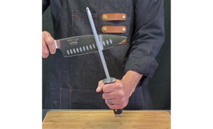 Image of a person using a pro Series 2.0 honing rod to hone a knife mid stroke