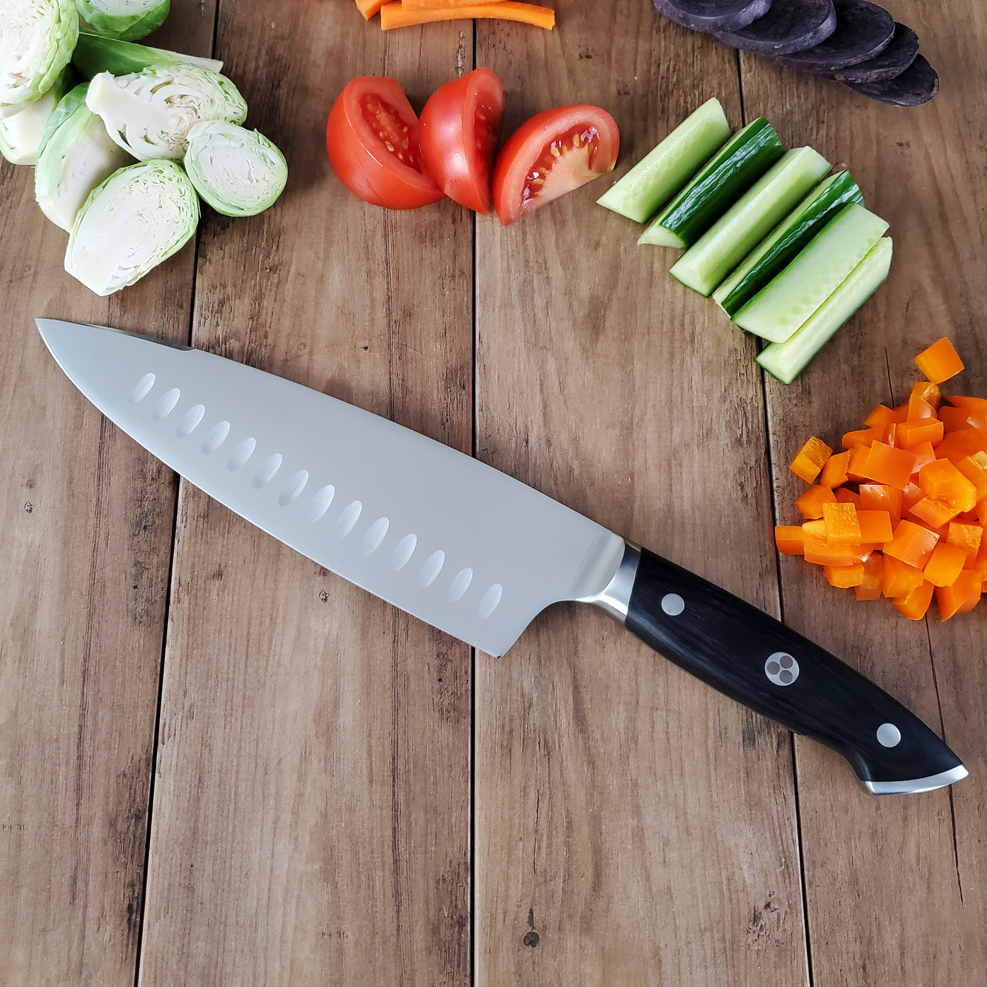 Pro Series 8" Chef's Knife on cutting board next to freshly cut veggies.
